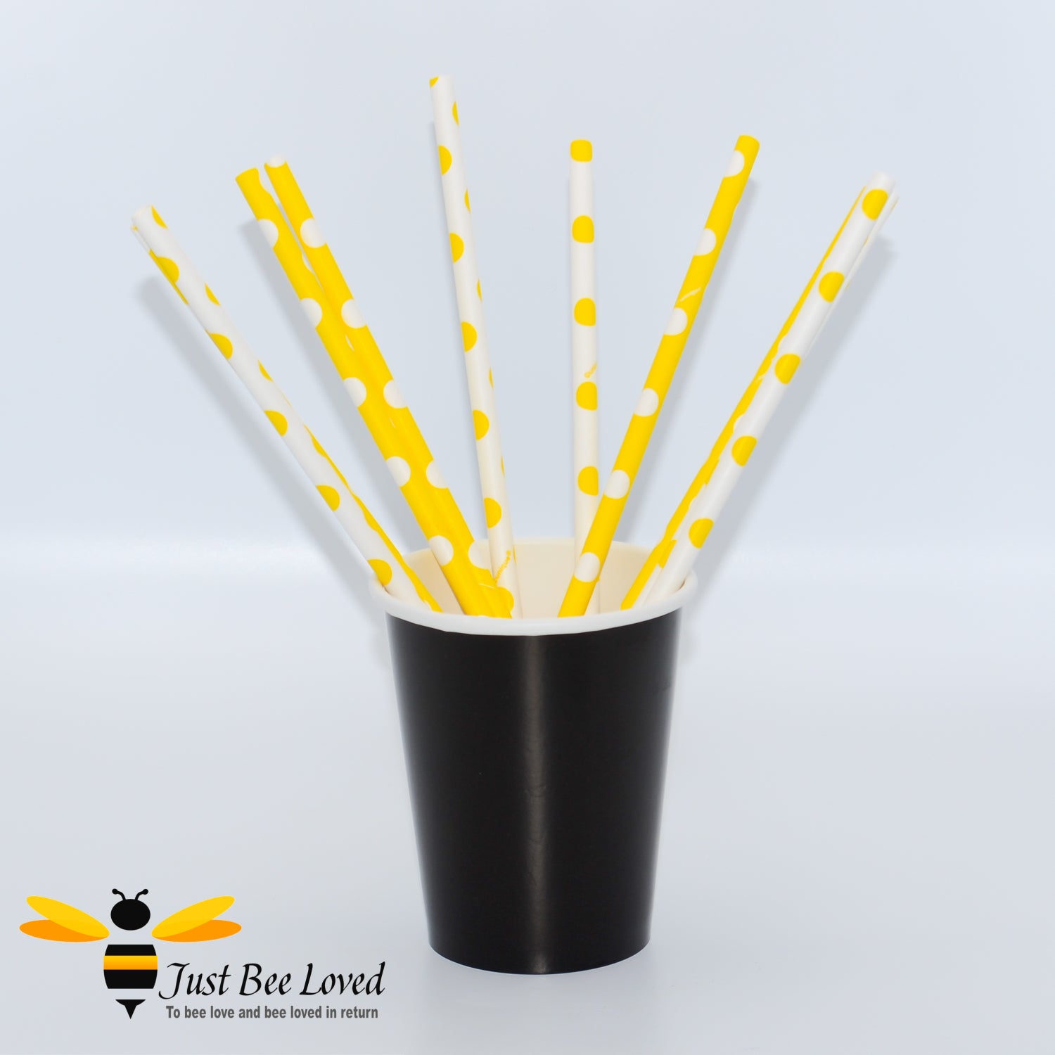 Yellow and white paper drinking straws with polka dot design.