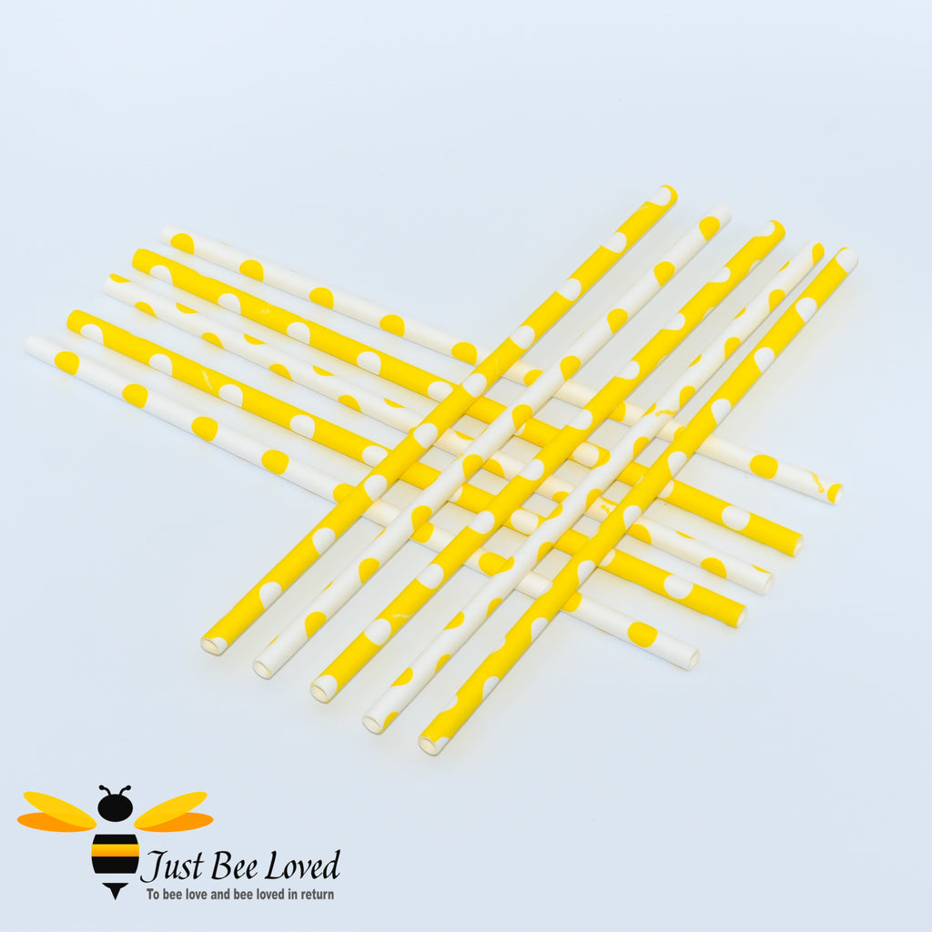 Yellow paper drinking straws with white polka dots.