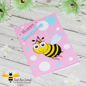 Just Bee Loved Little Bee Happy Birthday Greeting card for Girl featuring bumble bee wearing a party hat and balloons design by Artist Yasmin Flemming
