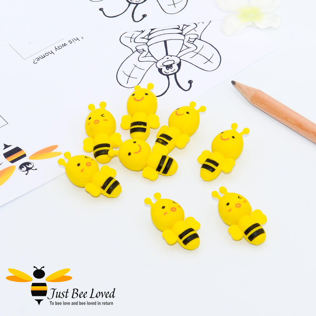 A set of 8 bee shaped yellow pencil erasers.