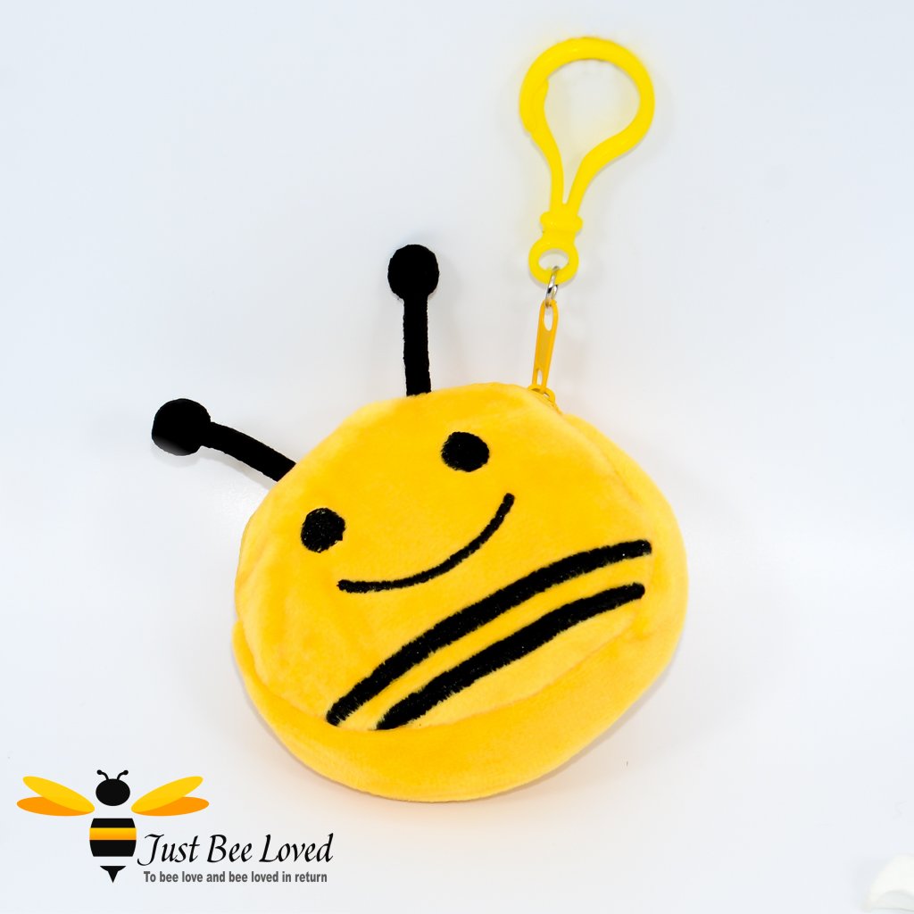 A plush keychain mini pouch designed to look like a bee with a smiling face, yellow with black stripes.