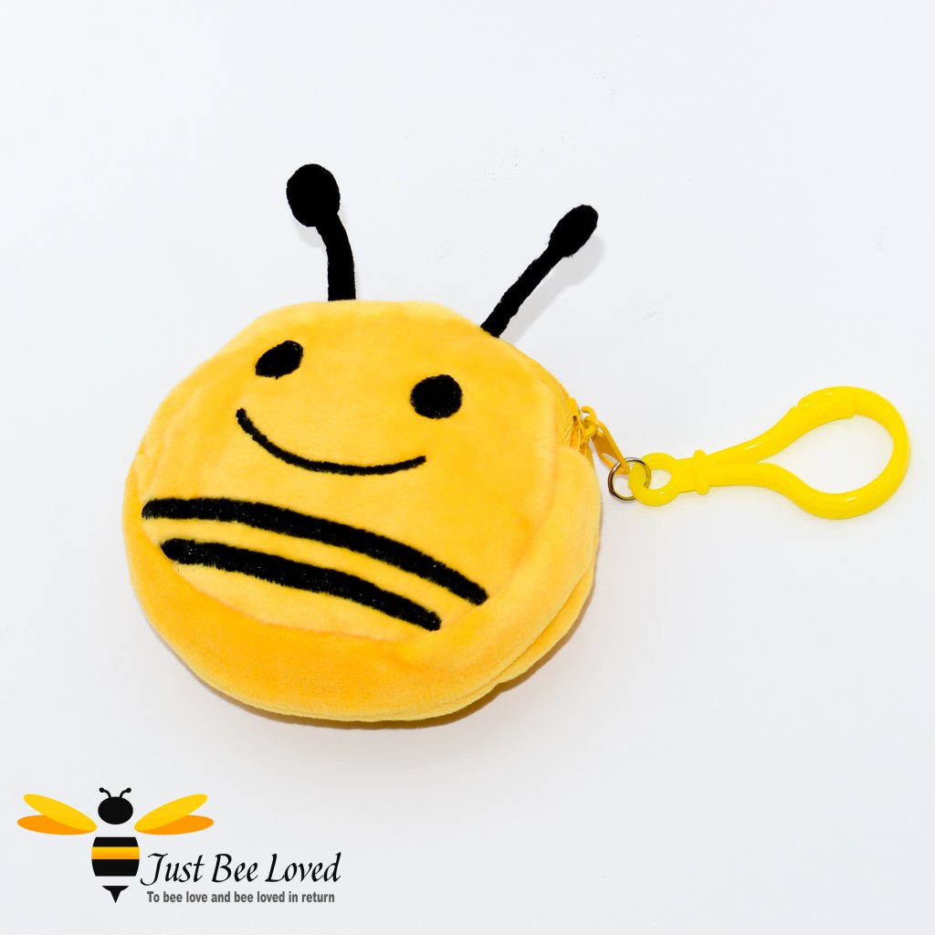 A plush keychain mini pouch designed to look like a bee with a smiling face, yellow with black stripes.