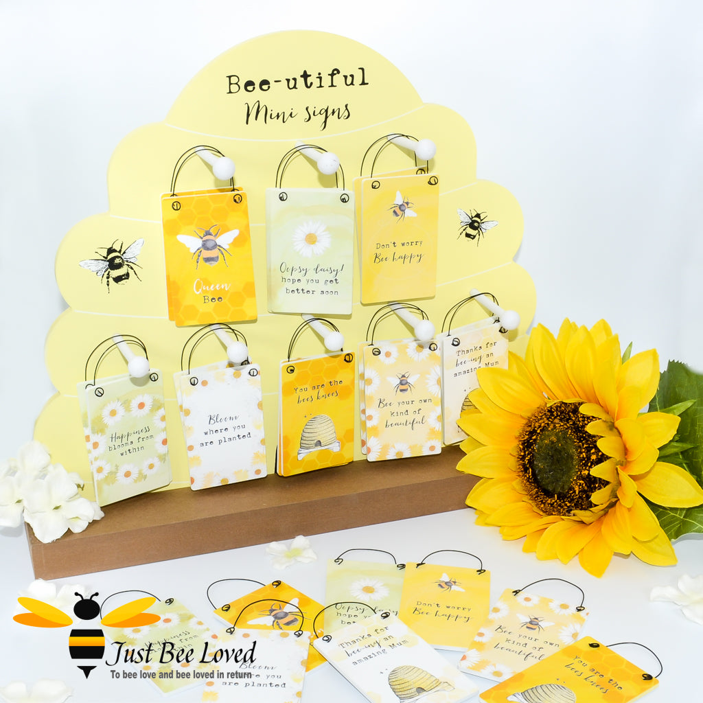 A collection of yellow wooden mini cards with bee-related graphics and various messages such as 'You are the bees knees' and 'Bee your own kind of beautiful'.
