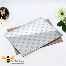 Load image into Gallery viewer, set of two glass mirrored placemats decorated with glittering bees on the front face and glittering gold underside.