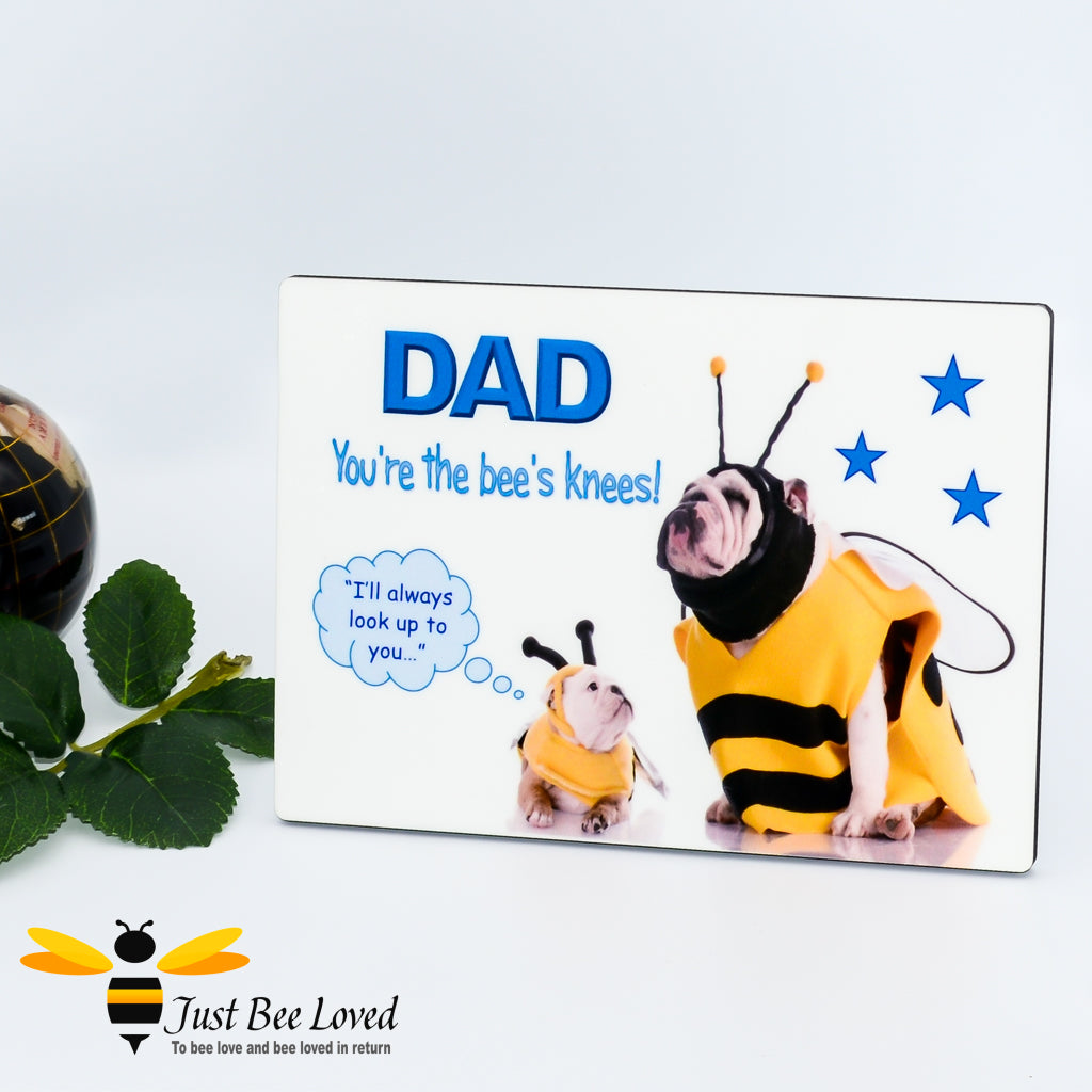 Wooden desk plaque with "Dad you're the bee's knees" text, showing two English bulldogs dressed in bee costumes representing father and son.
