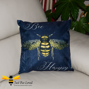Large scatter cushion featuring a classic design of a golden bee amongst beautiful calligraphy and the joyful message "Bee Happy" in dark navy colour.