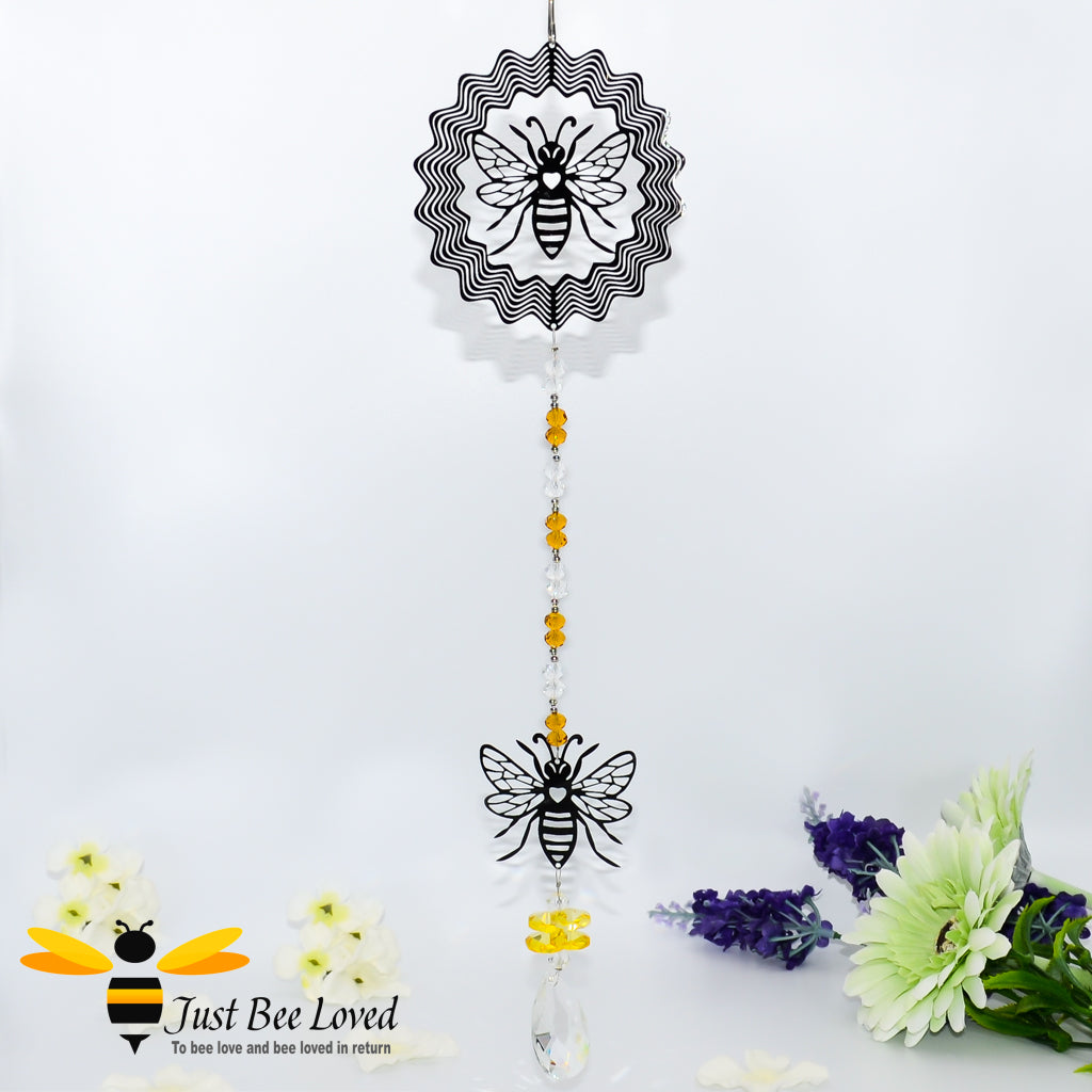 hanging silver wind spinner featuring the design of two bees with honey coloured crystals and oval chandelier crystal.