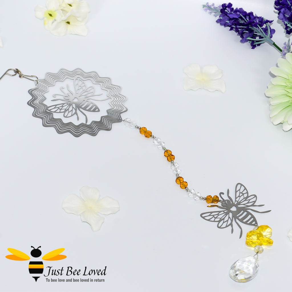 hanging silver wind spinner featuring the design of two bees with honey coloured crystals and oval chandelier crystal.