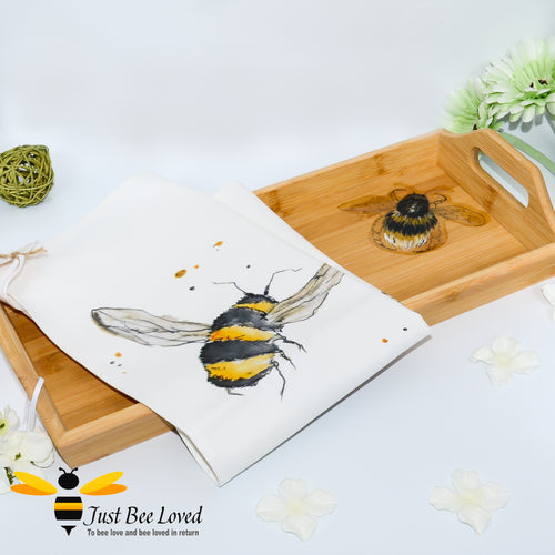 bamboo serving tray hand-painted by British artist Joanna Williams; featuring a painting of a bumblebee, with matching bee print cream cotton tea towel