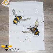 Load image into Gallery viewer, luxurious cream coloured cotton tea-towel featuring bumblebees in flight art work by British artist Joanna Williams.
