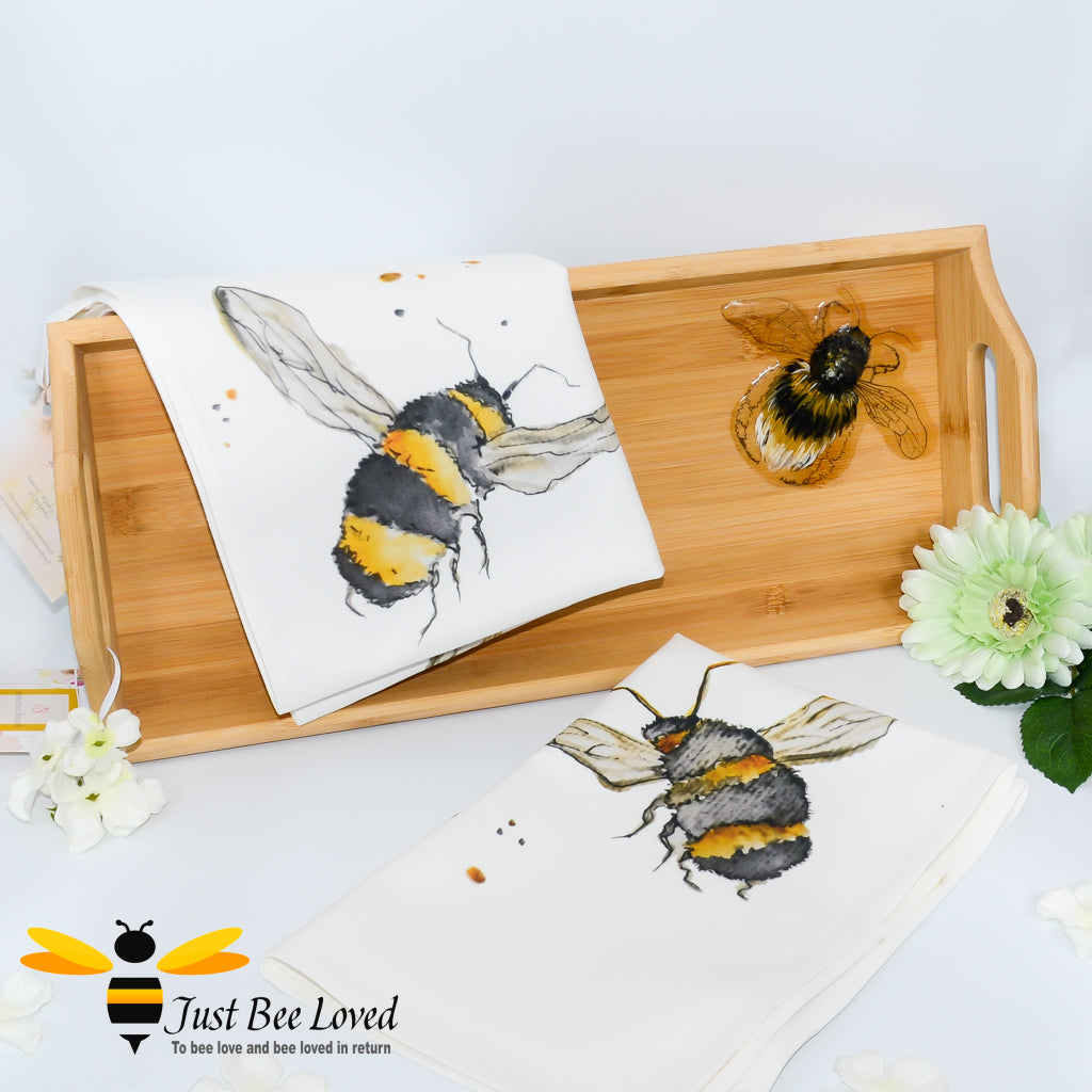 bamboo serving tray hand-painted by British artist Joanna Williams; featuring a painting of a bumblebee, with matching bee print cream cotton tea towel