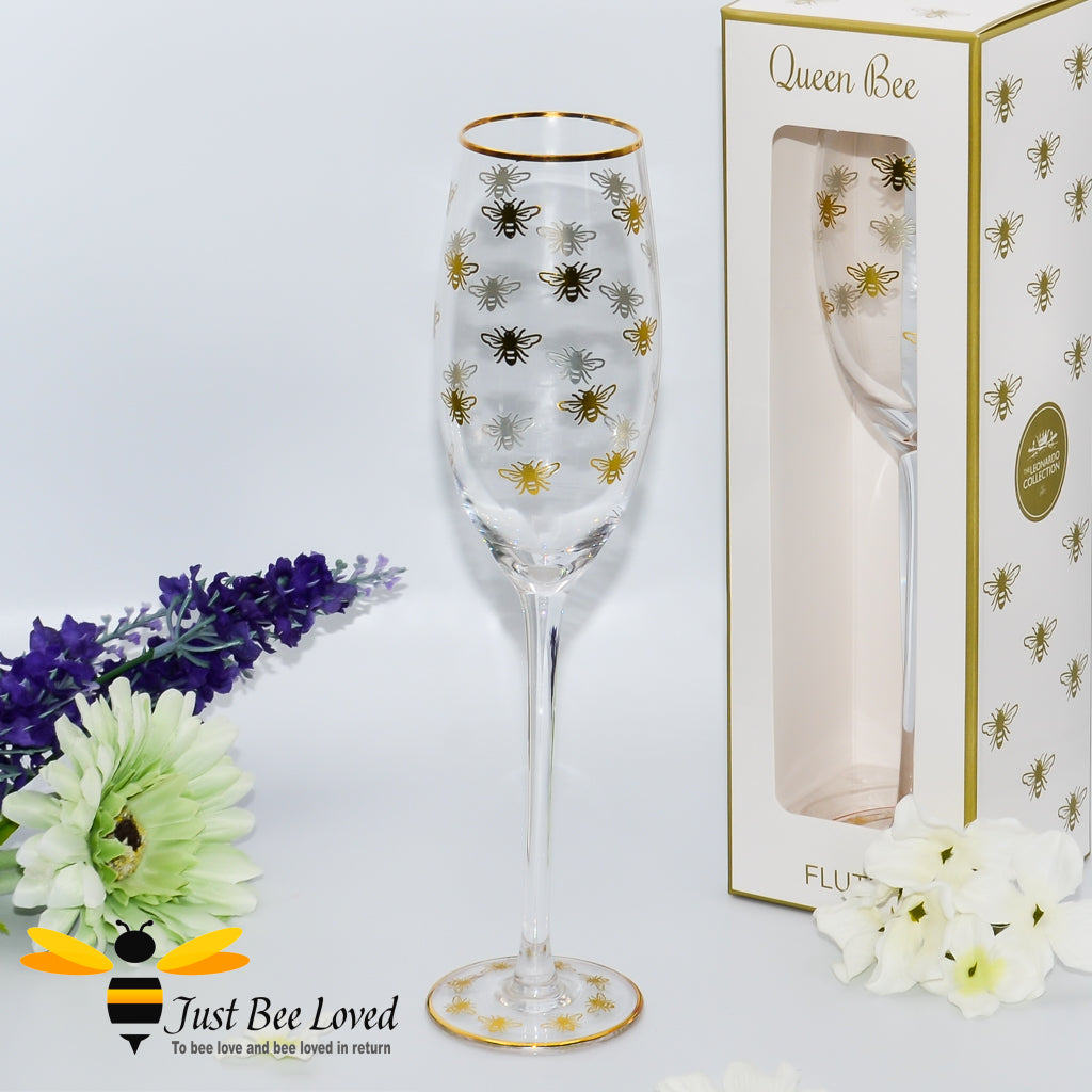 tall stemmed champagne flute glass decorated with golden bees and gold rim