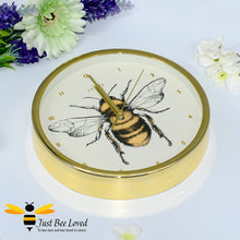 Load image into Gallery viewer, crafted round wall clock; designed with a gold rim casing and featuring a stunning bumblebee central print with gold Arabic dial and matching hands.