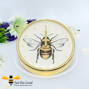 crafted round wall clock; designed with a gold rim casing and featuring a stunning bumblebee central print with gold Arabic dial and matching hands.