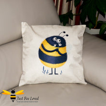 Load image into Gallery viewer, Large scatter cushion featuring a colourful image of a sweet bumblebee presenting flowers on a natural background.  