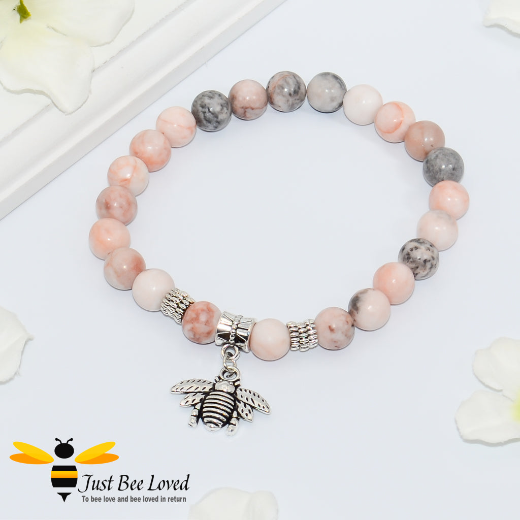 Handmade mottled pink and grey natural stone bead bracelet featuring  a silver bee charm. 
