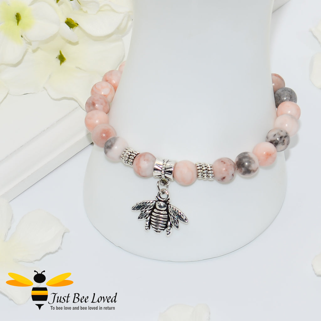 Handmade mottled pink and grey natural stone bead bracelet featuring a silver bee charm. 