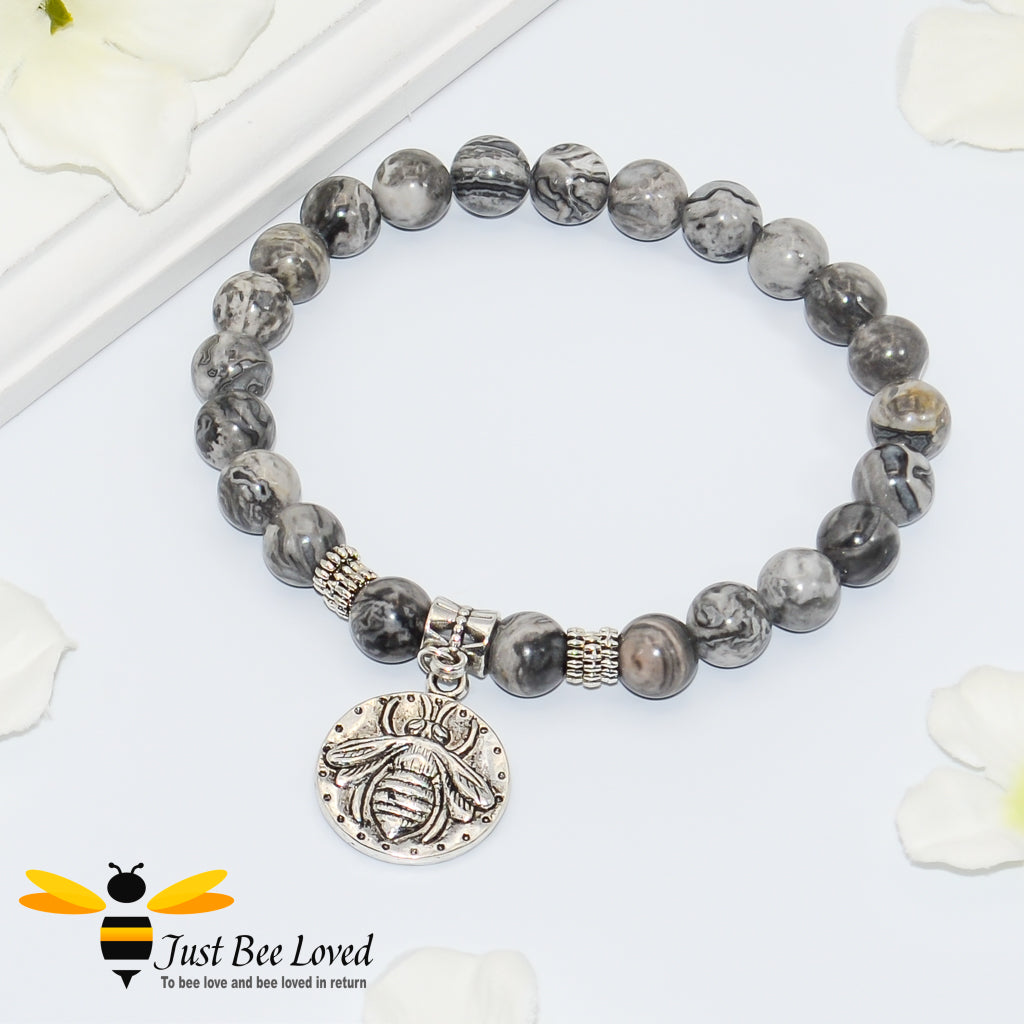 Handmade mottled grey natural stone bead bracelet featuring silver bee charm. 