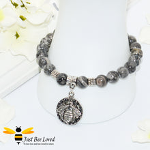 Load image into Gallery viewer, Handmade mottled grey natural stone bead bracelet featuring silver bee charm. 