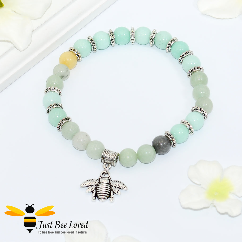 sea green beaded bracelet featuring antique silver bee charm. 