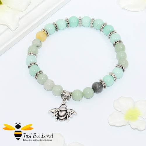 green bead bracelet featuring antique silver bee charm pendant. 