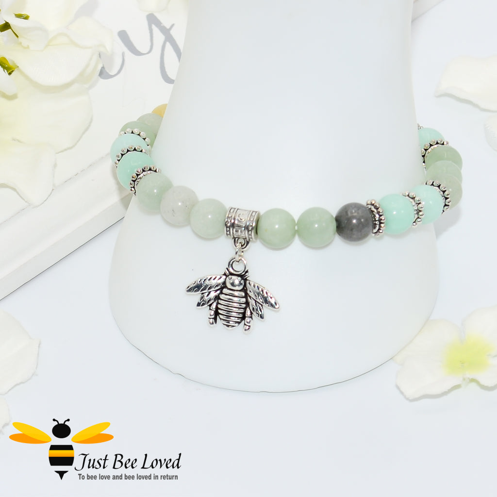 sea green beaded bracelet featuring antique silver bee charm. 