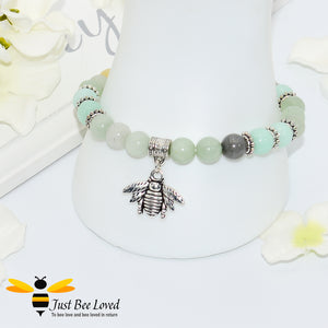 green bead bracelet featuring antique silver bee charm pendant. 