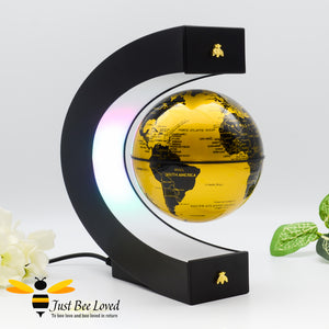 Floating levitation anti gravity black and gold globe desk lamp featuring two matching gold bees.