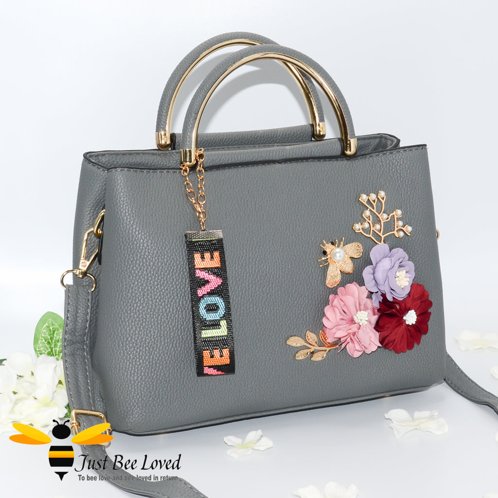 hand-crafted 3D embellished PU leather shoulder handbag featuring a cluster bouquet of colourful flowers, golden leaves with a pearlised bee in grey colour