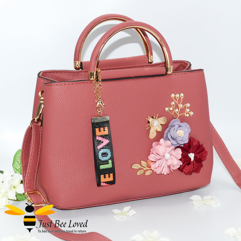 hand-crafted 3D embellished PU leather shoulder handbag featuring a cluster bouquet of colourful flowers, golden leaves with a pearlised bee in pink colour