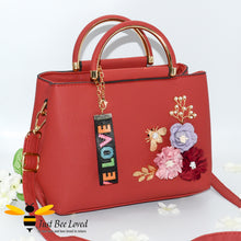 Load image into Gallery viewer, hand-crafted 3D embellished PU leather shoulder handbag featuring a cluster bouquet of colourful flowers, golden leaves with a pearlised bee in red colour