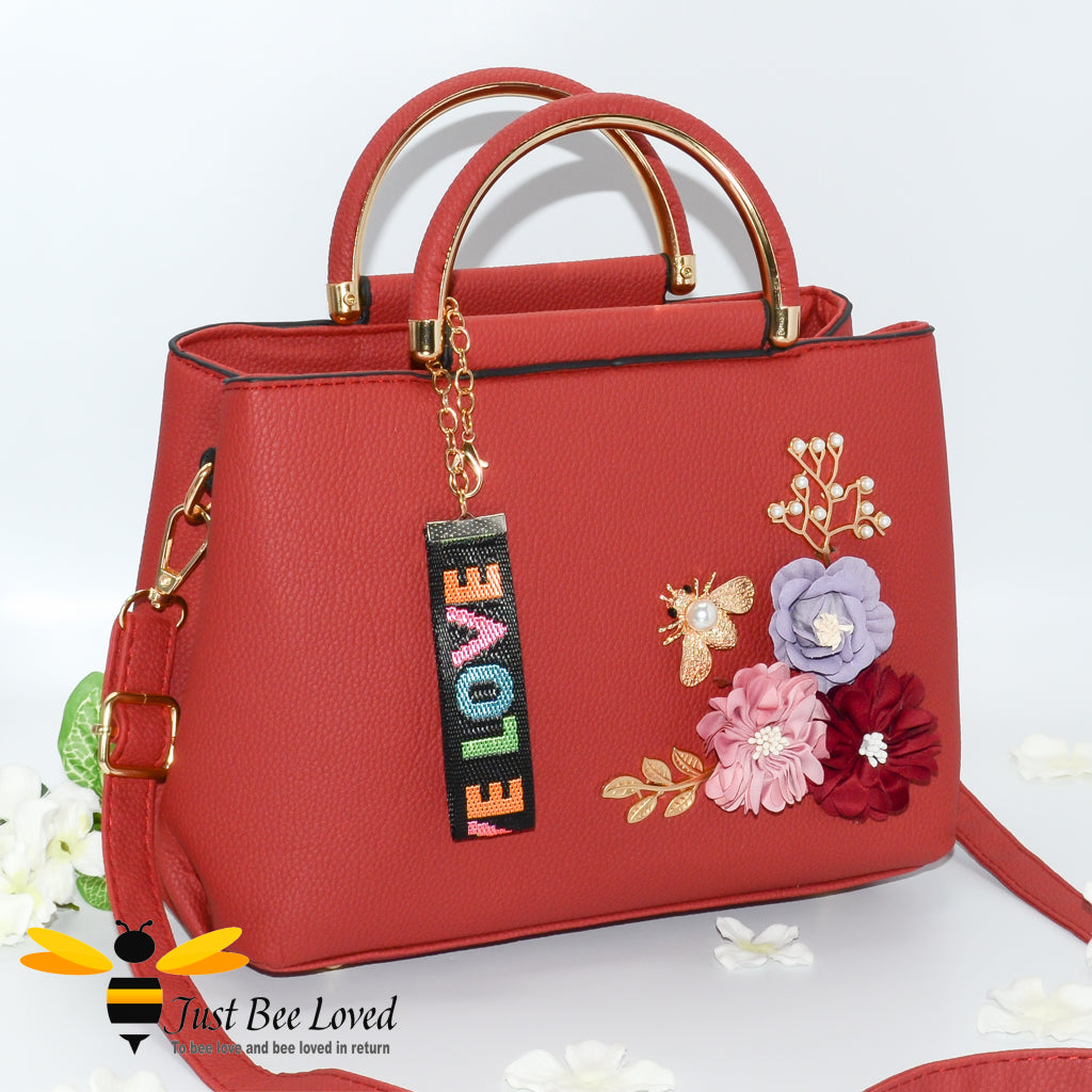 hand-crafted 3D embellished PU leather shoulder handbag featuring a cluster bouquet of colourful flowers, golden leaves with a pearlised bee in red colour