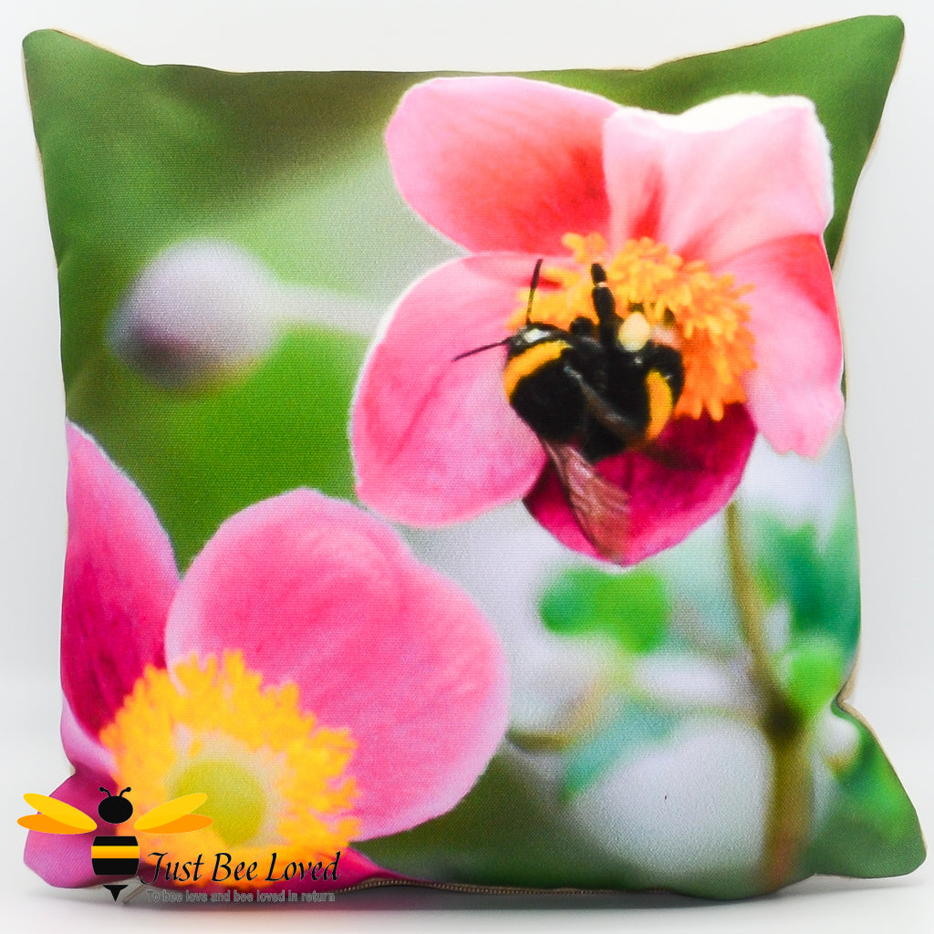 Small scatter cushion featuring a photographic image of a bumblebee foraging on pink flowers.
