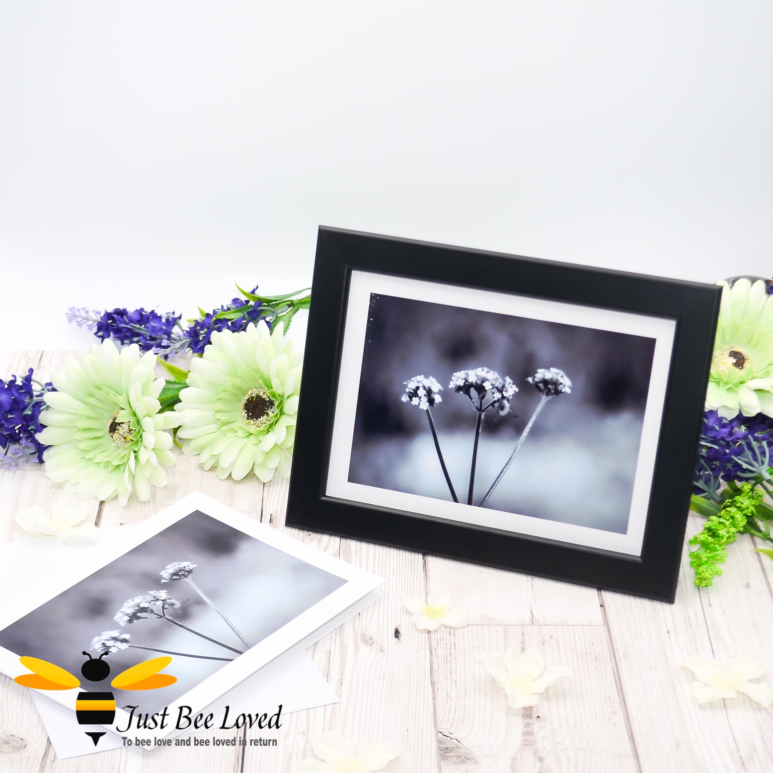 Framed photographic greeting card featuring a black and white image of a bee on a misty morning foraging on white flowers.