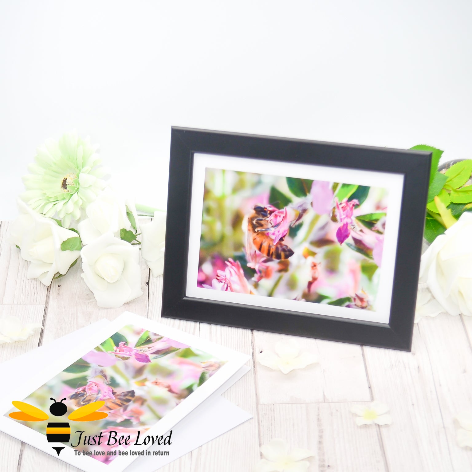 Framed photographic greeting card featuring an image of a honey bee foraging on wild pink flowers.