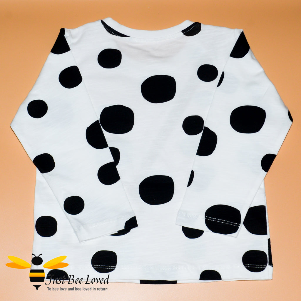 Girl's long sleeve white cotton top featuring multi-sized black polka dots with applique bumblebee handbag design