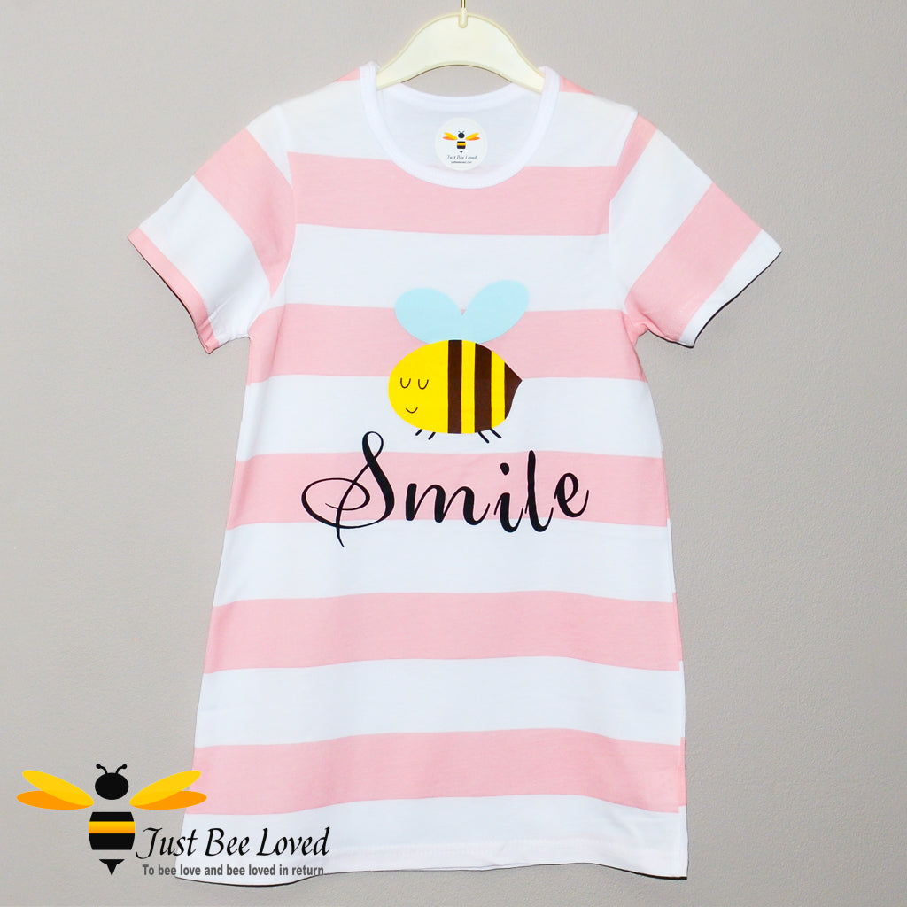 girl's pink & white striped nightdress featuring a cartoon bee with "smile" text