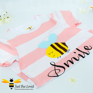 girl's pink & white striped nightdress featuring a cartoon bee with "smile" text