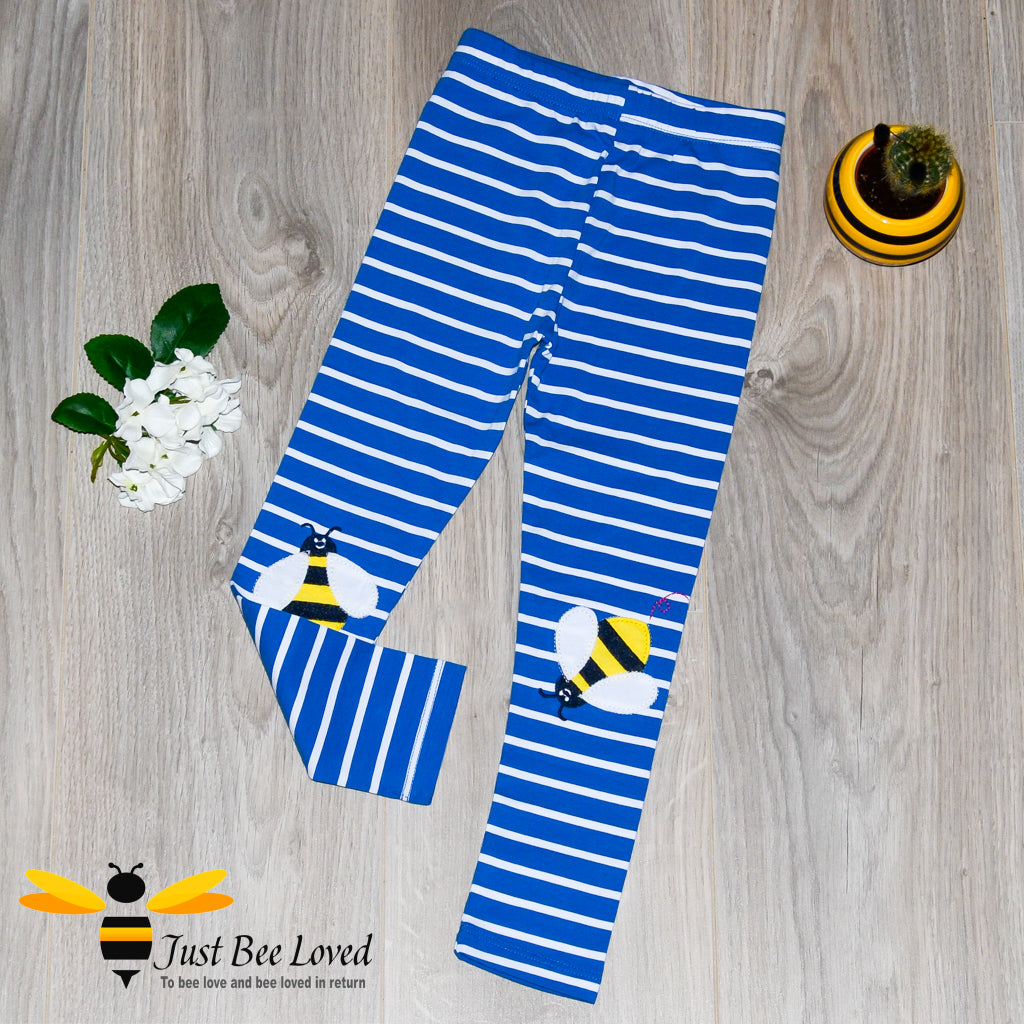 girl's blue and white striped leggings with bee applique on each knee.