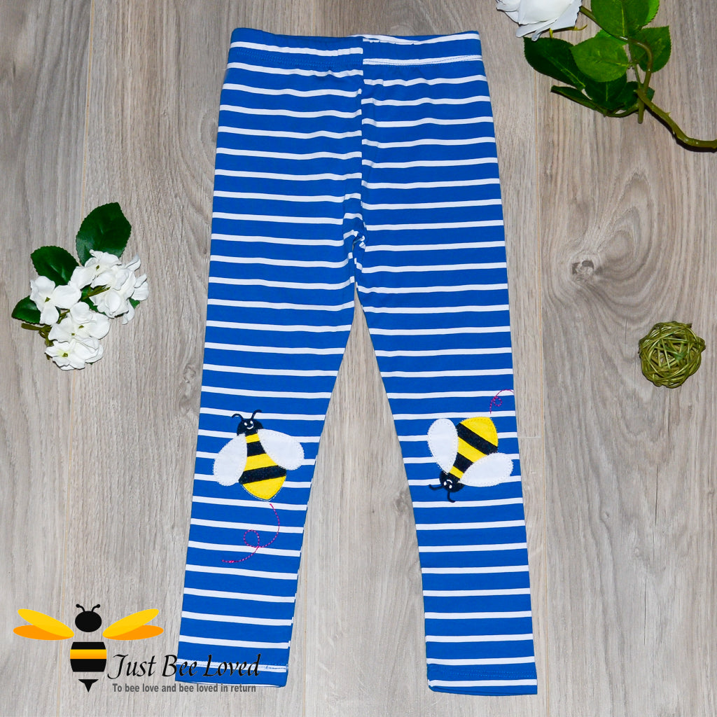 girl's blue and white striped leggings with bee applique on each knee.