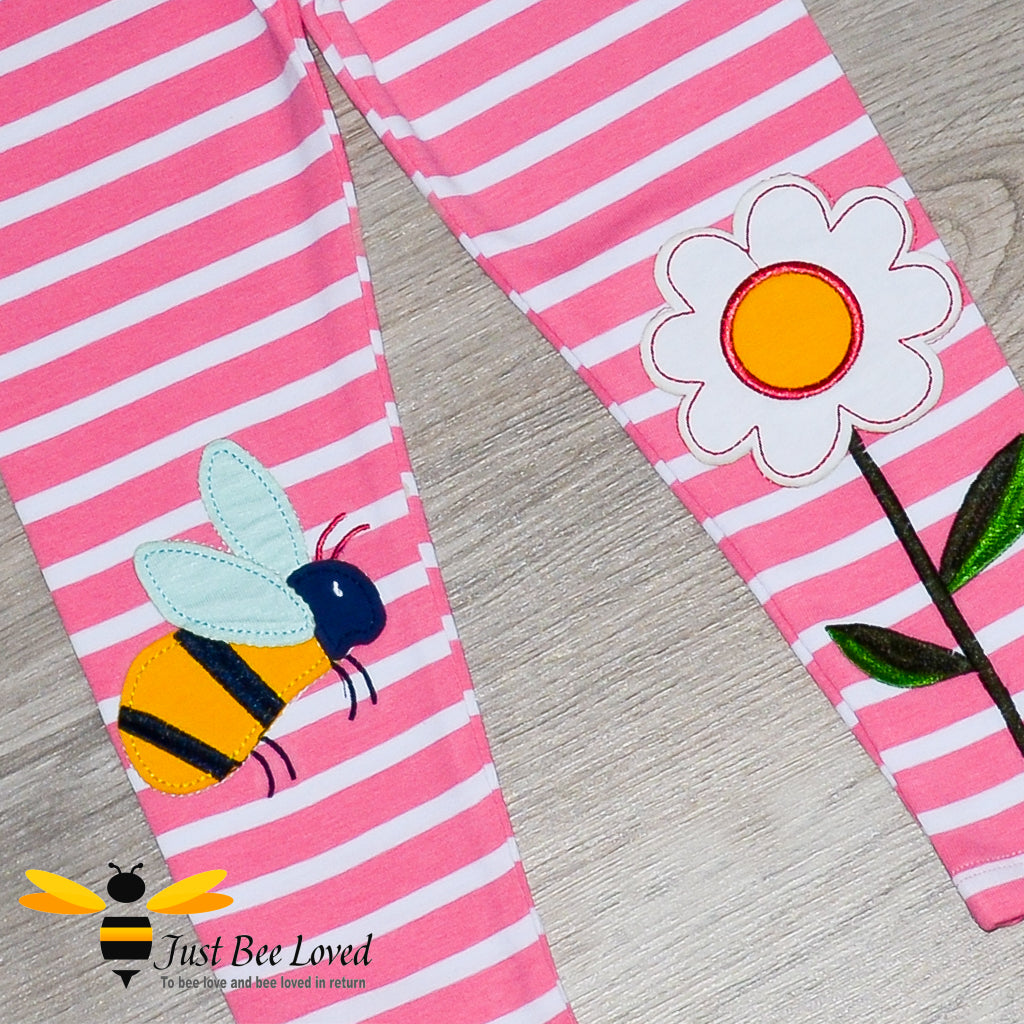 Girls pink striped leggings featuring colourful bumblebee and flower appliques at the knees.