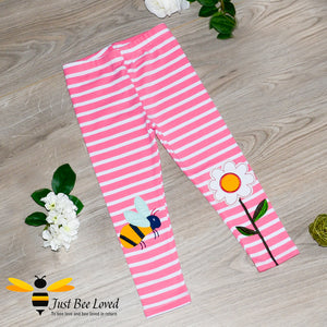 Girls pink striped leggings featuring colourful bumblebee and flower appliques at the knees.