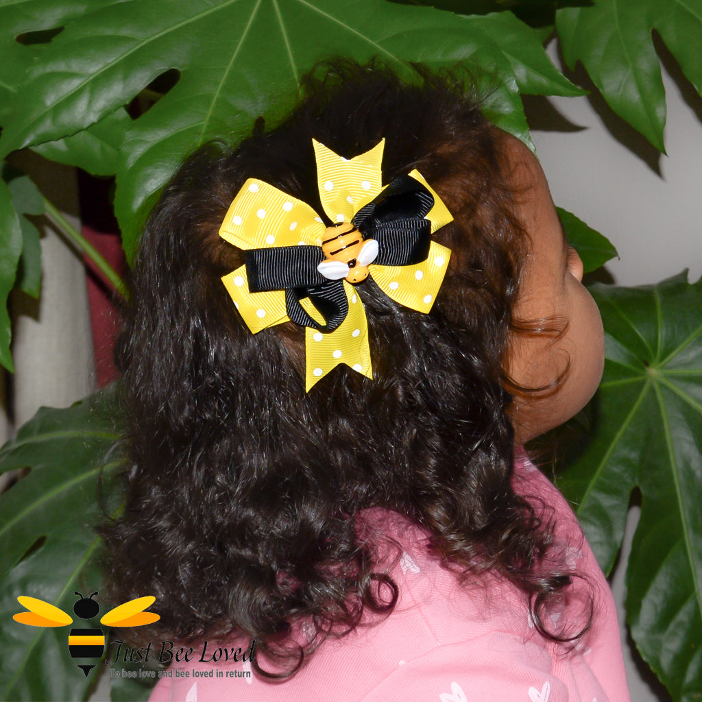 Girl wearing a bee themed ribbon bow hair clip