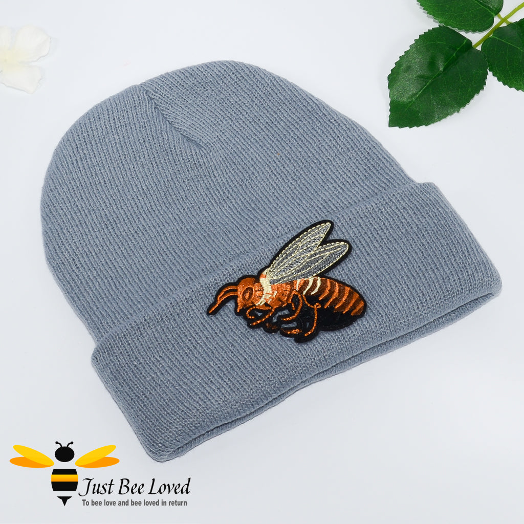 Grey ribbed knit beanie skull caps featuring a large front embroidered bee motif.