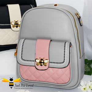 PU leather backpack featuring quilted flap-over front compartment with gold and cream bumblebee buckle clasp in grey and pink colour