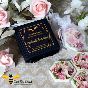 Gift boxed scented botanical wax tablets decorated with gold bee and pink natural dried flowers.