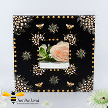 Load image into Gallery viewer, Hand painted wood black mirror featuring an original mandala design of gold and white with golden bumblebees.