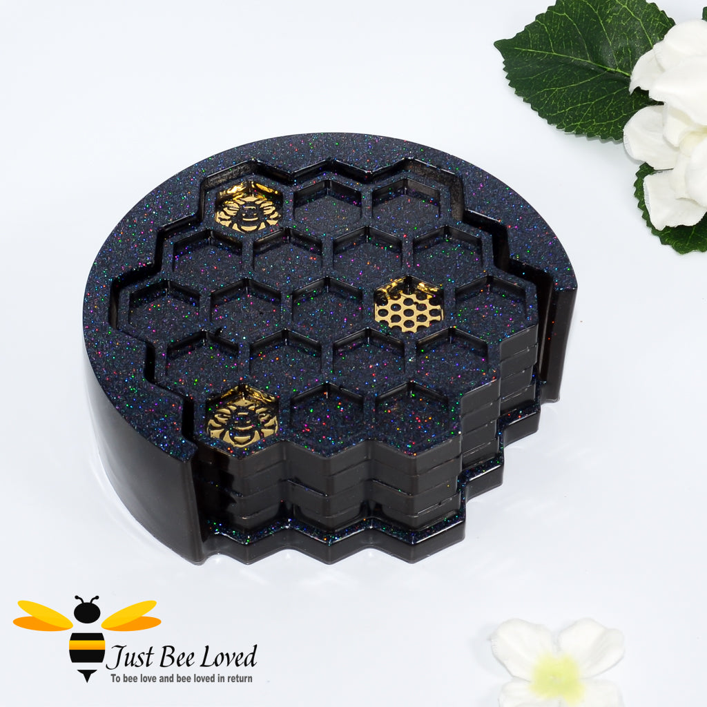 Set of 4 handmade resin honeycomb bee coasters with matching holder in black and gold.