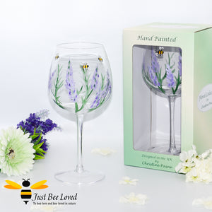 hand painted tall stemmed balloon wine glass with bumblebees and lavender flowers designed by UK artist Christine Paine. 