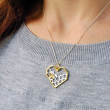 Load image into Gallery viewer, Lady wearing a sterling silver honeycomb heart with bee pendant necklace